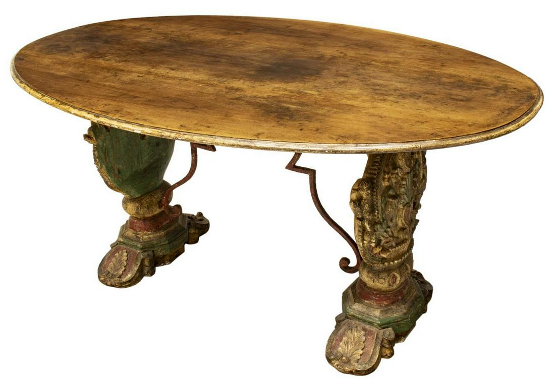 WINE TABLE FASHIONED FROM ARCHITECTURAL ELEMENTS: Italian table fashioned from architectural elements, possibly Sicilian, having walnut oval top, polychrome painted base, with carved religious motif including sacred heart, putti, and palmettes, joine