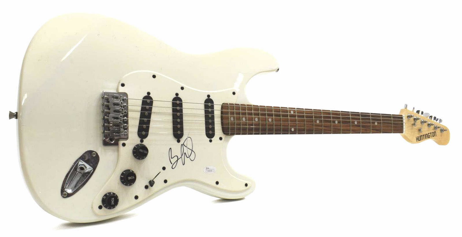 SIGNED BRAD PAISLEY JSA CERTIFIED ELECTRIC GUITAR: Huntington six-string electric guitar, signed at the pick guard by country singer and songwriter Brad Paisley (b.1972), JSA certification number Z26530, approx 39.25"l, 12.75"w **Provenance: Eight Poi
