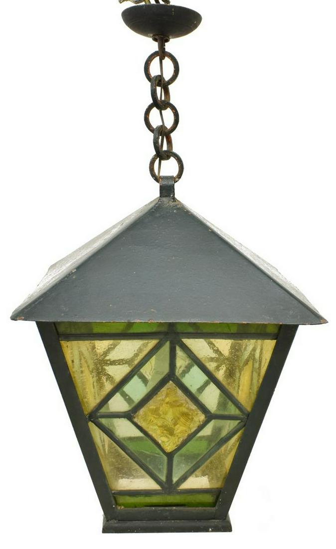 ARTS & CRAFTS STYLE STAINED GLASS HANGING LANTERN: English Art and Crafts style hanging lantern, early 20th c., lantern-form, stained and leaded glass panes with diamond pattern, loss to three panes, approx 23.25"h, 18"w, 18"d Start Price: $100.00