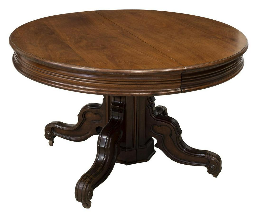 VICTORIAN SPLIT PEDESTAL EXTENSION DINING TABLE: Victorian extension table, late 19th c., circular tabletop, over conforming molded frieze, split center pedestal, rising on scrolled legs, on casters, approx 29.75"h, 47.5"diam, extended: approx 162.7