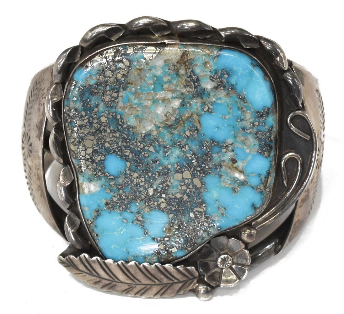 NATIVE AMERICAN SILVER TURQUOISE CUFF, SIGNED VERO: Native American silver (content unknown) and turquoise cuff bracelet, signed Vero, possibly David Vero, Navajo, open work frame with worked silver straps, large central floral and feather bezel holdin