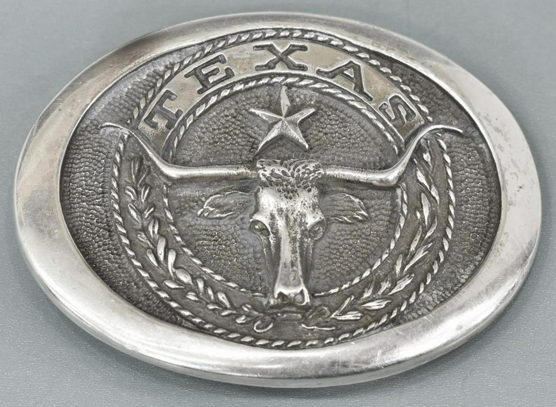 RUSSELL WATERHOUSE LONGHORN STERLING BELT BUCKLE: Texas longhorn sterling silver belt buckle, designed by Russell R. Waterhouse, 1997, Heritage Mint Ltd., marked verso "Purchased by Sidney M. Carroll, SA-605 of 5000, 2-23-81," approx 2.5"h, 3.5"w, 4.