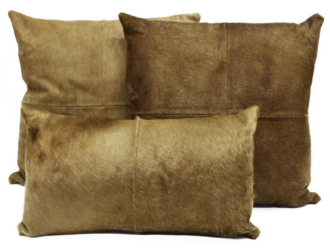 (3) DECORATIVE COWHIDE THROW PILLOWS: (lot of 3) Decorative cowhide pillows, largest: approx 21"h, 20"w; 14.75lbs total Start Price: $50.00