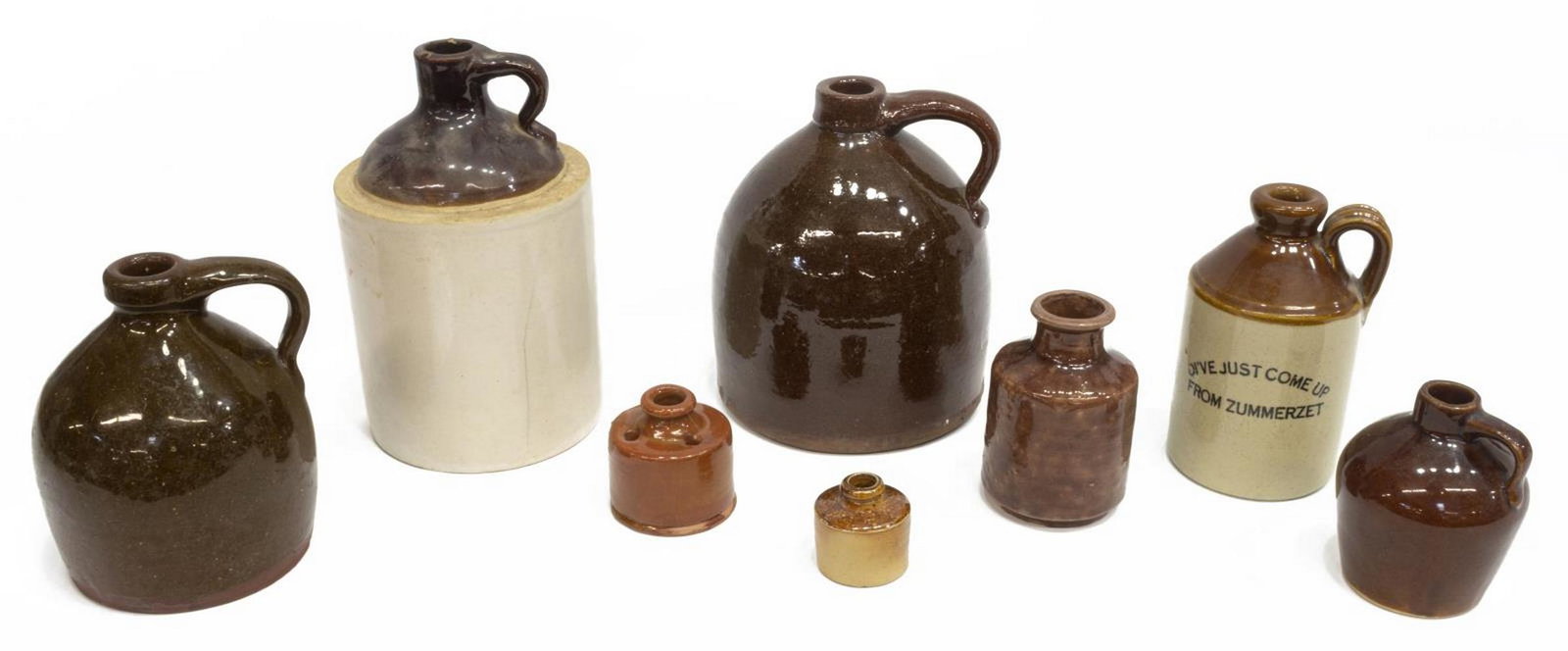(8) AMERICAN GLAZED STONEWARE JUGS & INKWELLS: (lot of 8) American stoneware jugs and inkwells, late 19th/ early 20th c., all in brown glazing, highlights include: (1) cider flagon, inscribed with Oi've just come up from Zummerzet, Somerset, Texas