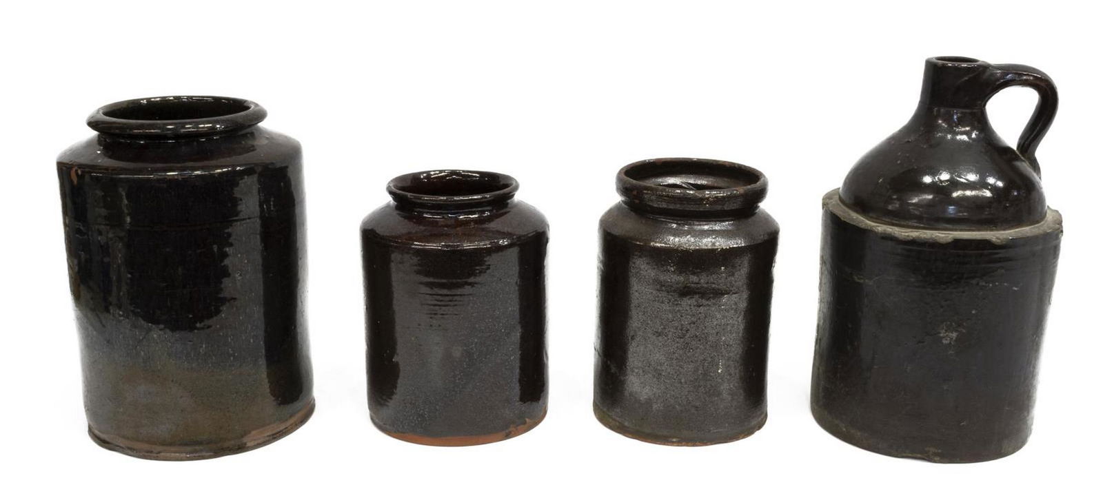 (4) AMERICAN ALBANY SLIP REDWARE JARS & WHISKY JUG: (lot of 4) American redware jars and jug, late 19th c., all in an Albany slip, including: (3) graduated jars, cylindrical form, tapered shoulders, flared lip, each with slight chipping to glaze, (1) j