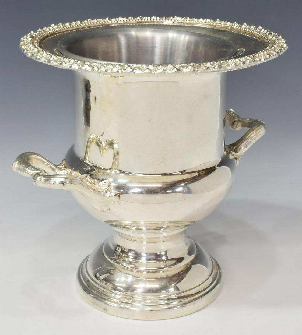 FANCY SILVER PLATE CHAMPAGNE WINE BOTTLE COOLER: Silver plate wine/ champagne bottle cooler, hallmarked M in shield, beaded and foliated rim and handles, interior liner, stepped pedestal foot, approx 10.25"h, 11"w, 5.25lbs (for shipping purposes onl