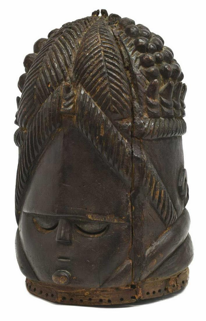 AFRICAN SIERRA LEON MENDE SOCIETY FEMALE MASK: African Sierra Leon Mende Sande society female mask, died black wood helmet, of hollowed ovoid form, having an elaborate coiffure, comprised of rounded and pointed elements, with leaf-like vertical se