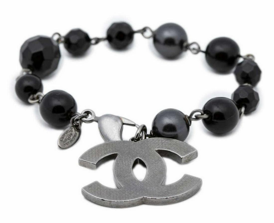 CHANEL FAUX PEARL BEADED BRACELET CC LOGO CHARM: Chanel faux pearl and beaded bracelet, stainless steal chain and CC logo charm, presented in branded box with dust bag, approx 8.25"l, 0.5lbs *Provenance: Luxury goods are offered in partnership with