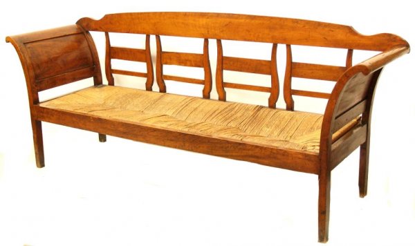 ANTIQUE RUSTIC SPAIN WALNUT RUSH SEAT BENCH: Good Spanish carved walnut rustic settee, early 19th century, a simple crest rail above four shaped splats, join curving, paneled arm supports, central rush seat with loss, wear, rising on squared sup