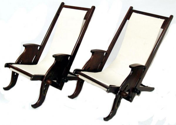 BRITISH COLONIAL ANTIQUE ROSEWOOD CAMPAIGN CHAIRS: Pair of good British Colonial rosewood folding campaign chairs, 19th century, with brass fittings, reclining seats with later canvas, restored, approx 35"h, 22"w, 50"l (canvas)