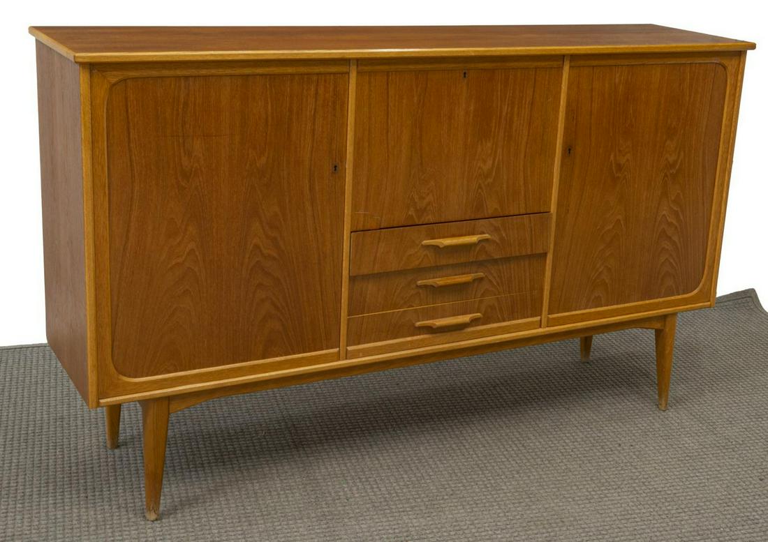 DANISH MID-CENTURY MODERN TEAK SIDEBOARD: Danish mid-century modern teak sideboard, c.1950s, side cabinets, centering drop-front bar cabinet, over three drawers, rising on tapered legs, restoration to veneer at bar cabinet door and right side