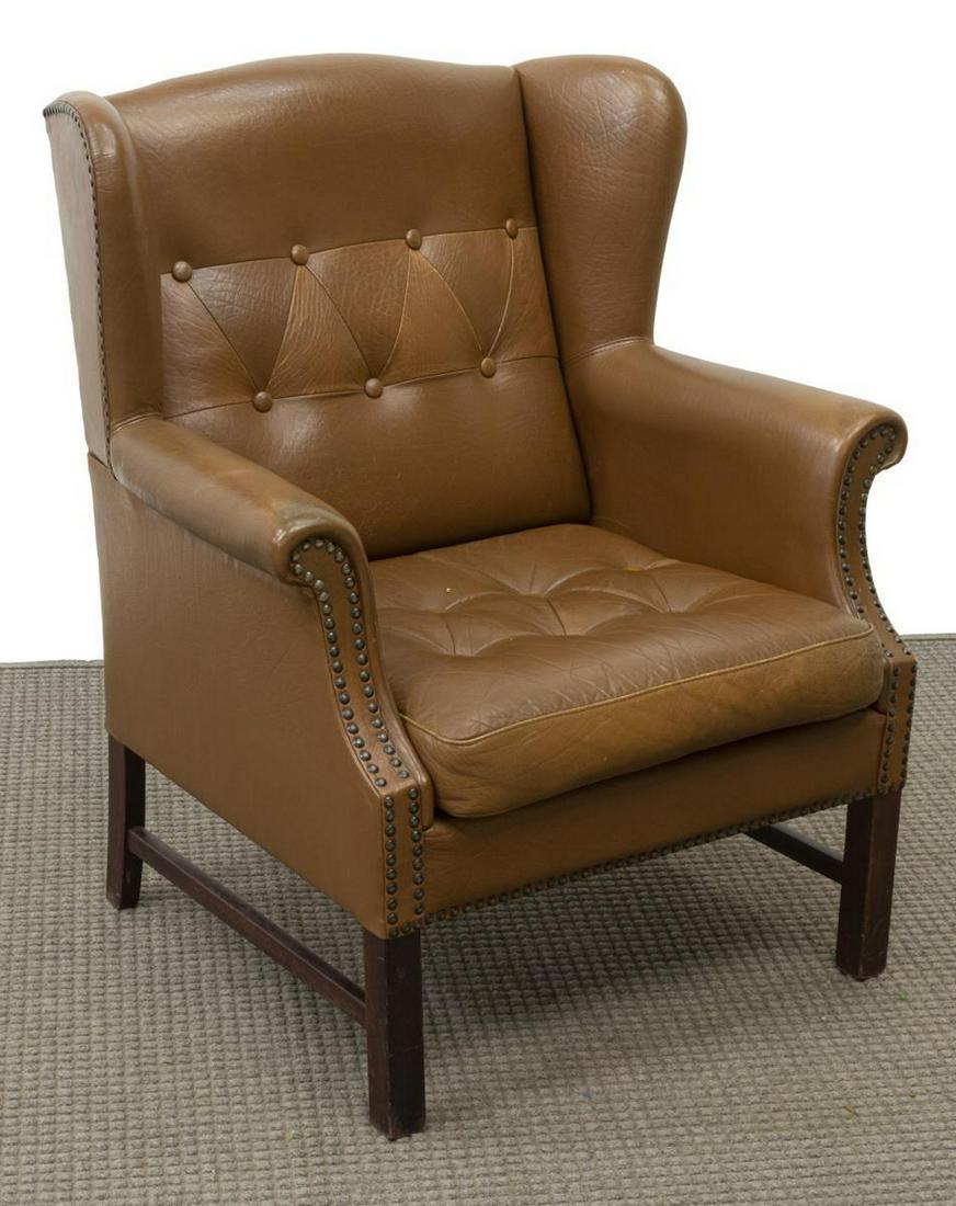 VINTAGE BUTTON-TUFTED LEATHER WINGBACK ARMCHAIR: Vintage leather wingback armchair, 20th c., button-tufted back and seat cushion, nail head trim, rising on stretcher-joined legs, creasing to leather, approx 37.25"h, 31.5"w, 26"d Start Price: $200.00