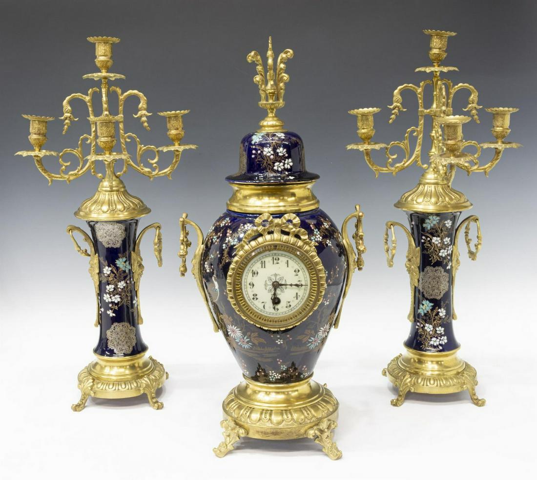 (3) FRENCH JAPY FRERES MANTEL CLOCK & GARNITURES: (3 piece) French mantel clock set, comprising: (1) clock, having time only movement, ceramic urn-form body, in cobalt glaze, with raised enamel Japonism design of peacock and flowering branches, white