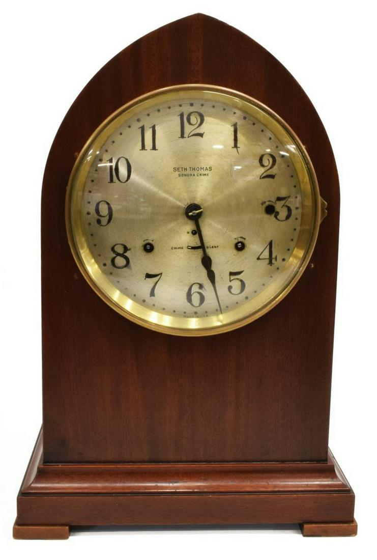 AMERICAN SETH THOMAS SONORA CHIME BEEHIVE CLOCK: American Seth Thomas mahogany Sonora Chime beehive clock, having case with arched top, time, strike, and chime movement, black Arabic numerals, sub dial for chime/silent, hinged glass door, rising on