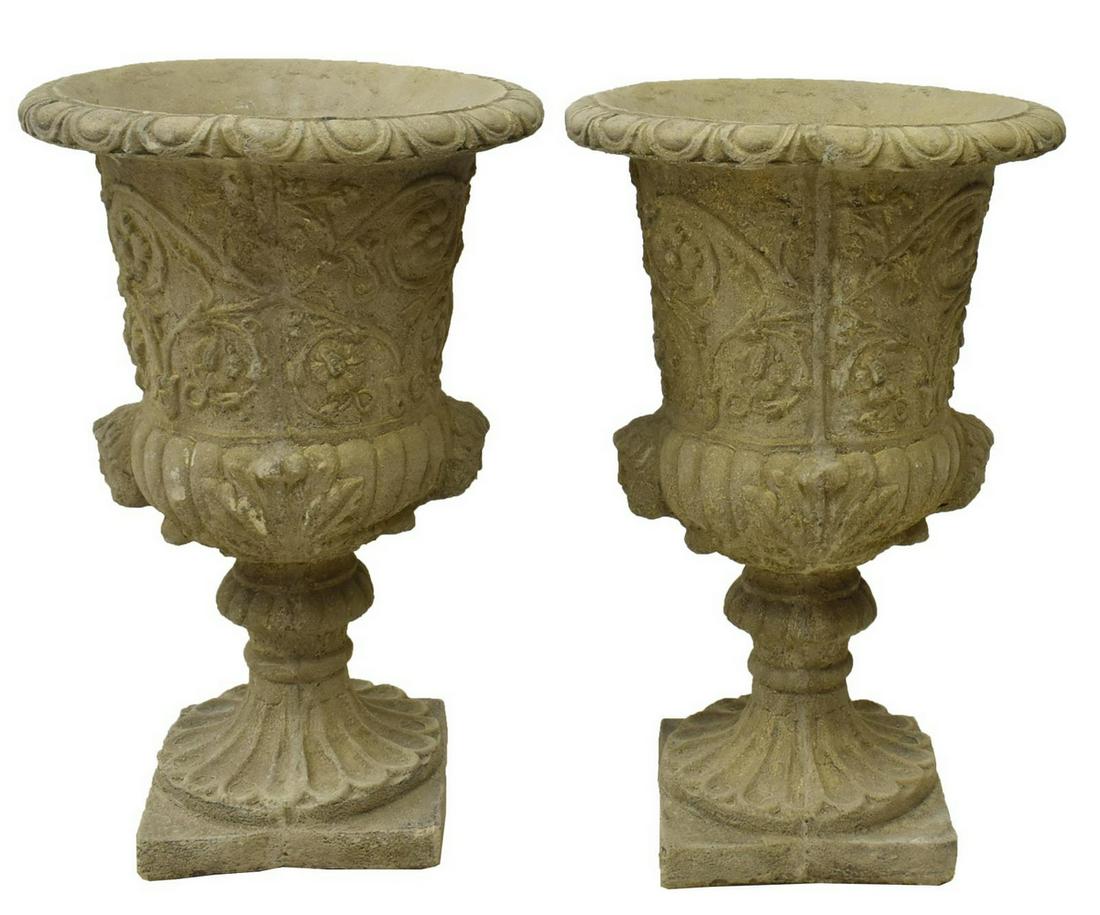 (2) CAST STONE CAMPAGNA-FORM GARDEN URNS: (lot of 2) Cast stone campagna-form garden urns, each having fluted rim, in egg and dart border, foliate elements and masks to body, rising on square base, each approx 23.5"h, 15.5"diam Start Price: $