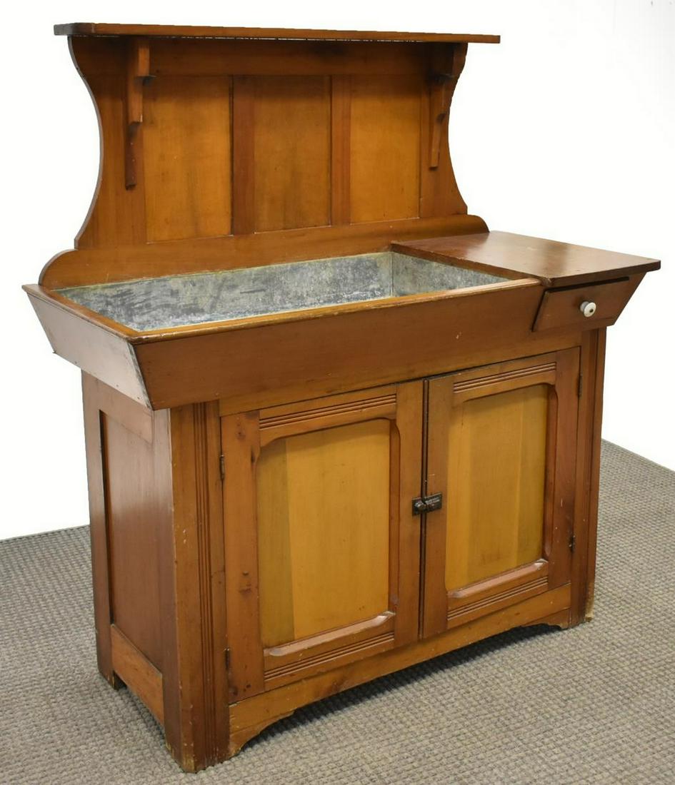 AMERICAN FRUITWOOD & ALUMINUM DRY SINK: American fruitwood dry sink, shaped back with open shelf, over shallow aluminum basin and small side drawer, lower case fitted with double-door cabinet, opening to shelved interior, rising on bracket
