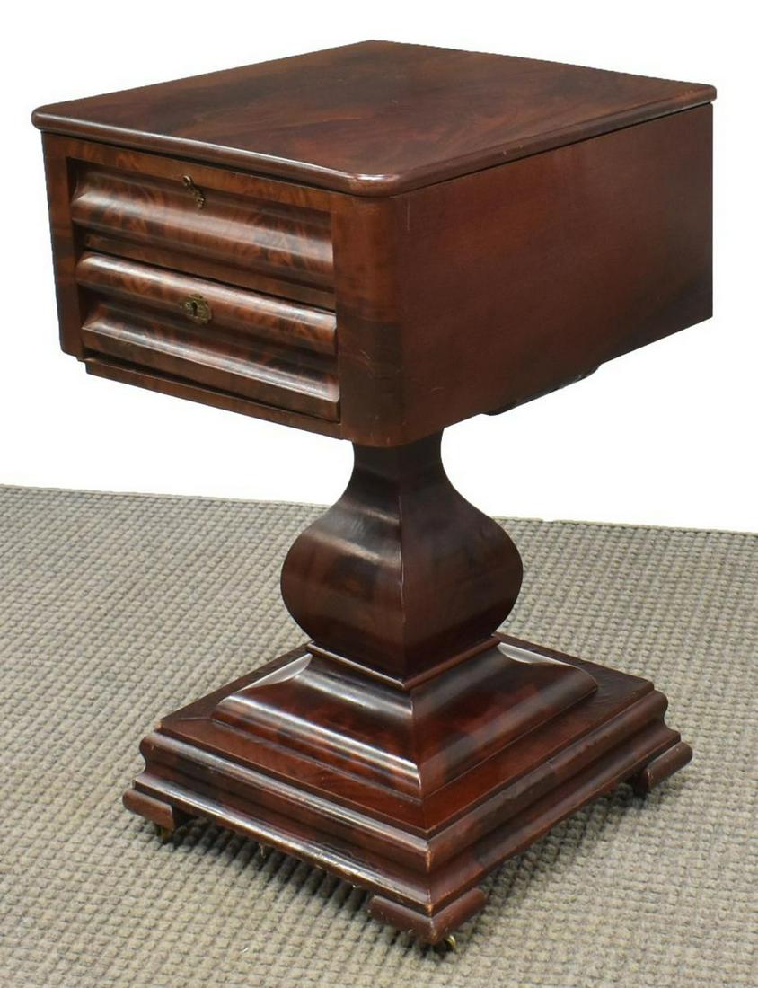 AMERICAN EMPIRE FLAME MAHOGANY WORK TABLE: American Empire flame mahogany work table, mid 19th c., hinged top opening to marquetry oval cartouche and divided interior, single ogee drawer below, vasiform standard, platform base rising on bracke