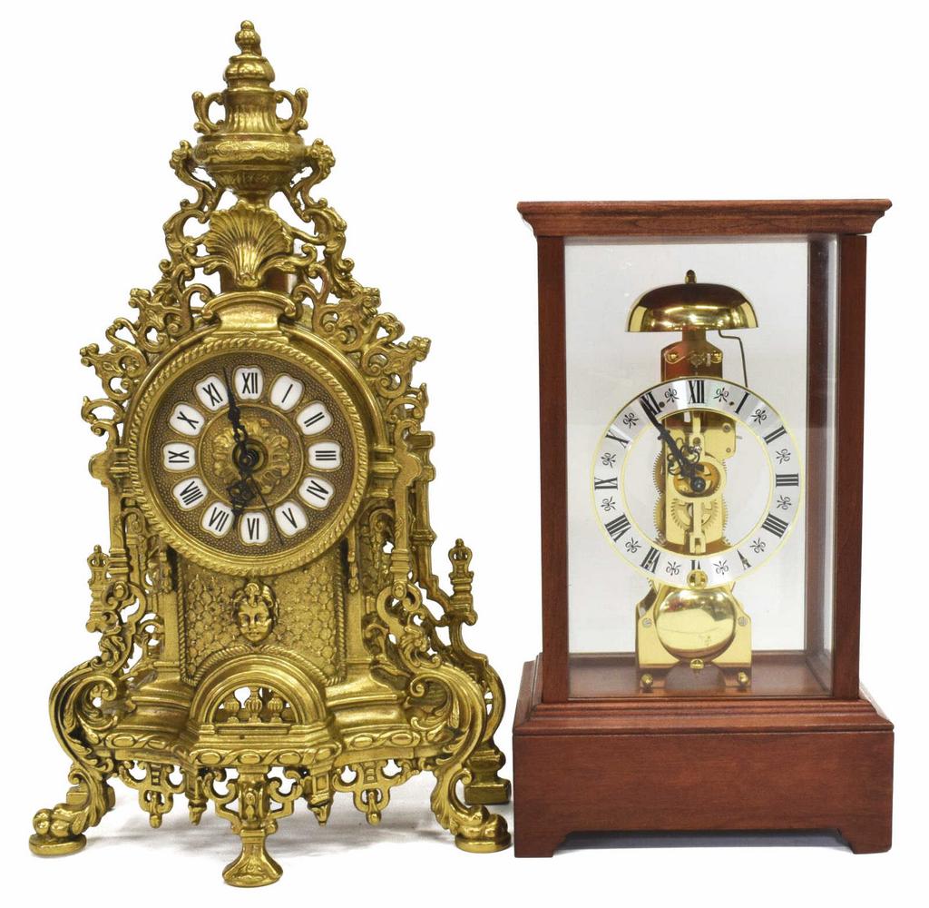 (2) FRANZ HERMLE SKELETON & GILT METAL CLOCKS: (lot of 2) Shelf clocks, 20th c., including: (1) with elaborate gilt metal case, enameled cartouches with roman numerals, battery operated time only movement, dial window lacking glass, approx 16.5"h,