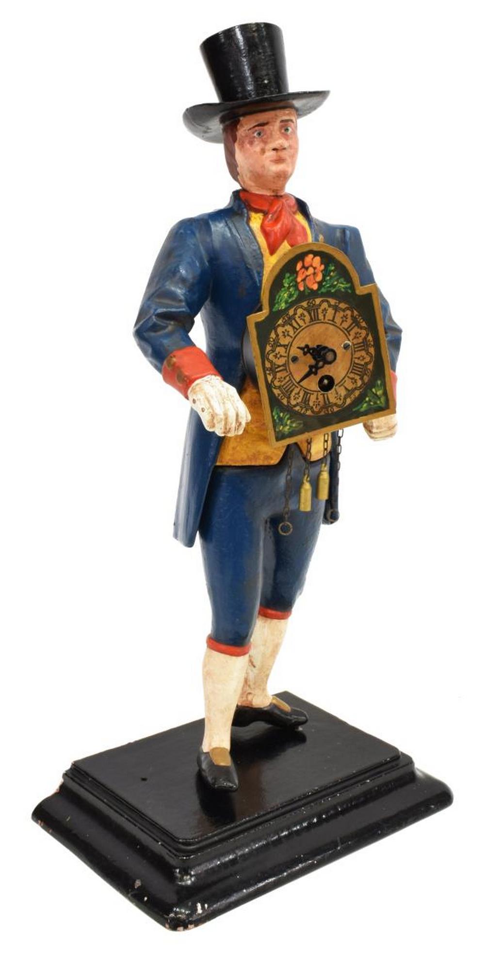 GERMAN PAINTED METAL CLOCK PEDDLER NOVELTY CLOCK: German painted cast metal figural novelty clock, mid 20th c., depicting a clock peddler in a top hat, lacking walking stick and pendulum, marked J.v.E. underfoot, approx 16"h, 8"w, 5"d Start Price: $5