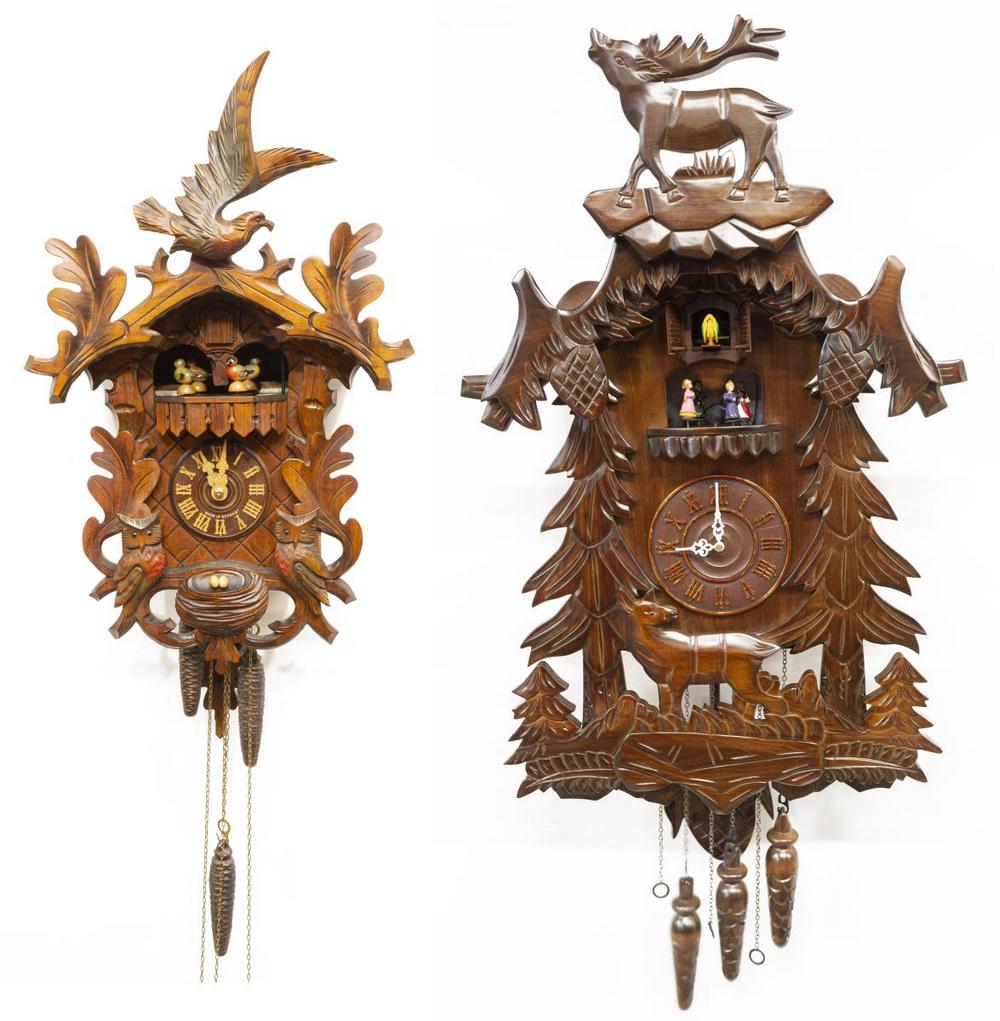 (2) HUBERT HERR & KENDAL WOOD CARVED CUCKOO CLOCKS: (lot of 2) Cuckoo clocks, comprising: (1) German Hubert Herr Black Forest clock, having walnut case, with rotating painted figures, carved owls, foliates, and bird's nest, with Swiss musical movement,