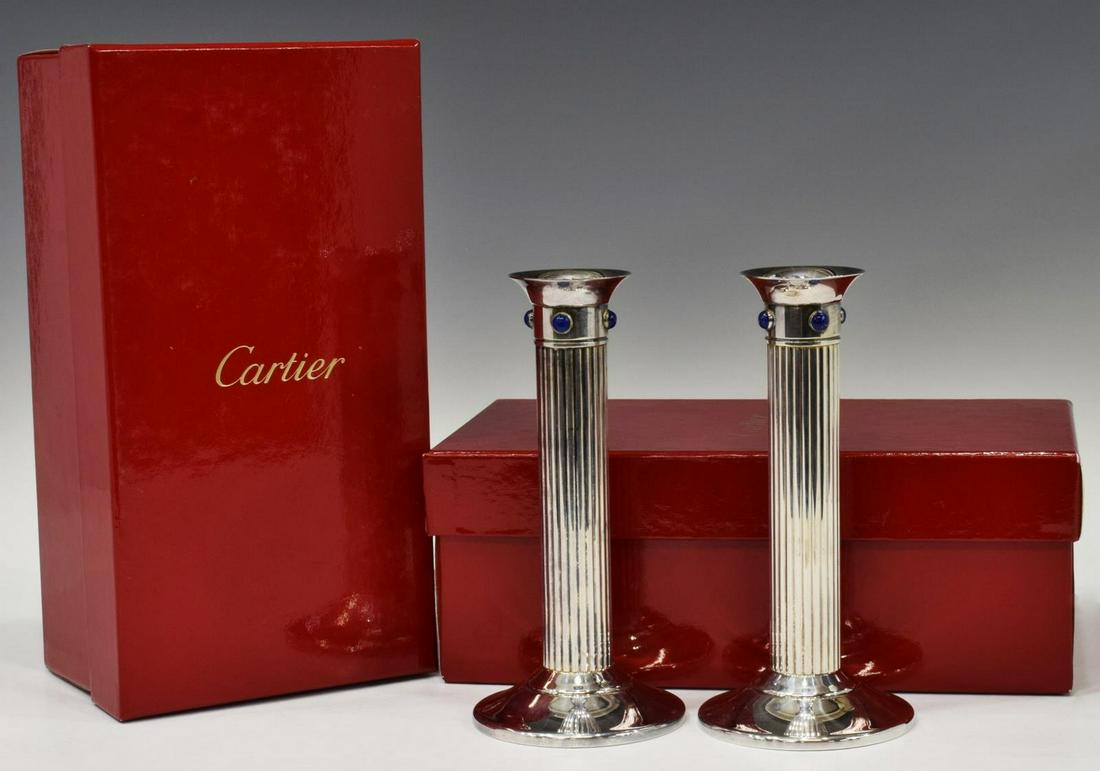 2) CARTIER SILVERPLATE LAPIS CABOCHON CANDLESTICKS: (lot of 2) French Cartier silver plate candlesticks, c.1989, four lapis lazuli cabochons over reeded standard, on a circular foot, each housed in branded box, approx 6.25"h, 3"diam; 2.25lbs total Star