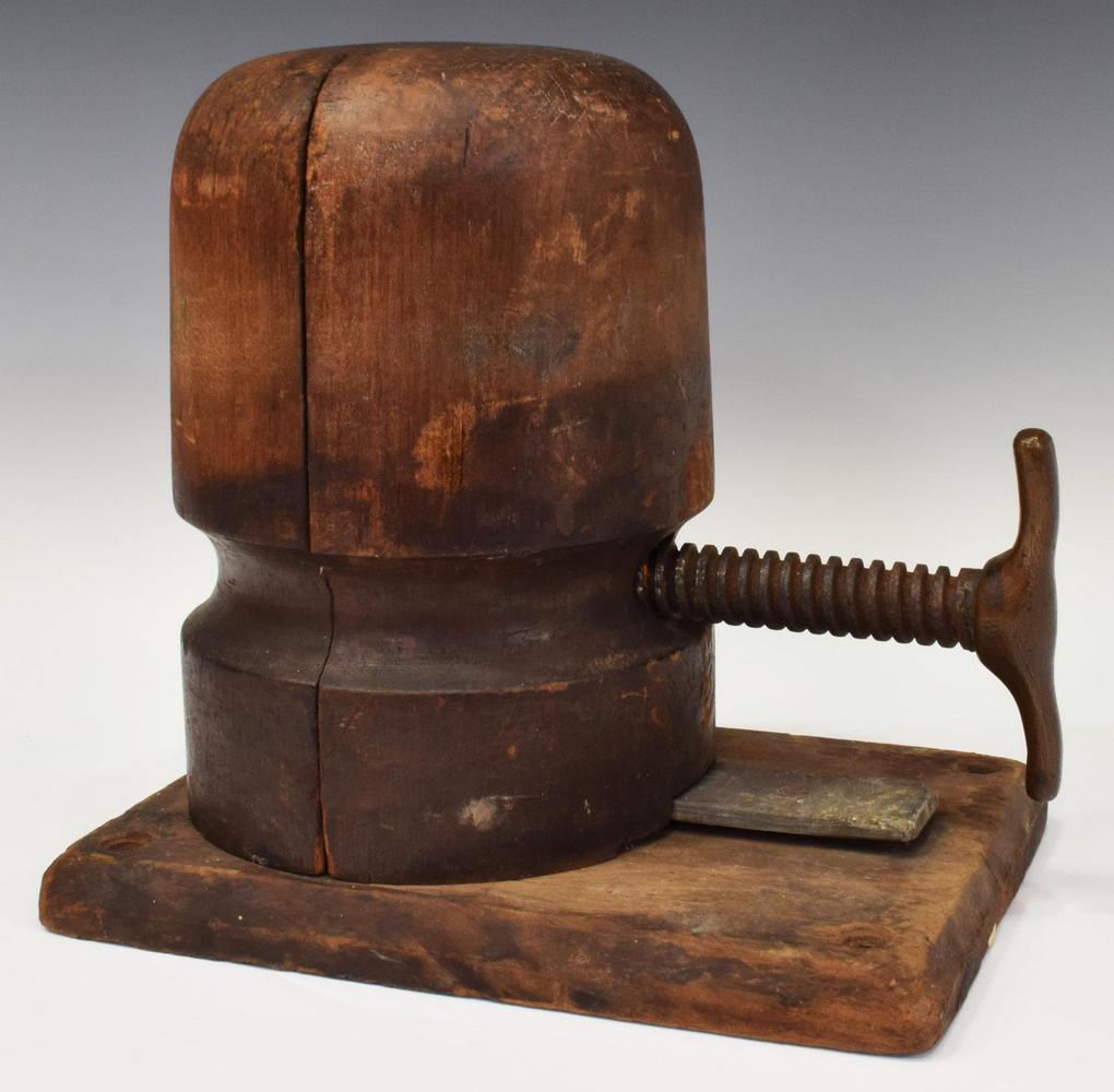 WOOD & METAL MILLINERY HAT STRETCHER/ BLOCK: Wood hat stretcher/ block, having an adjustable iron handle, on rectangular base, approx 10"h, 10.75"w, 7.5"d, 8.75lbs Start Price: $80.00
