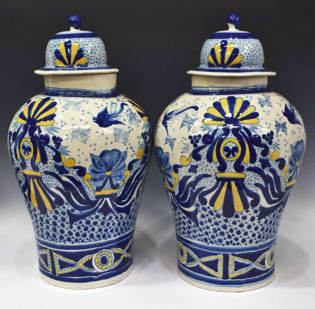 (2) URIARTE TALAVERA TIN-GLAZED LIDDED JARS: (pair) Uriarte Talavera tin-glazed earthenware lidded jars, Puebla, Mexico, with blue and yellow floral motif, approx 25"h, 14"diam, 40lbs total Start Price: $150.00