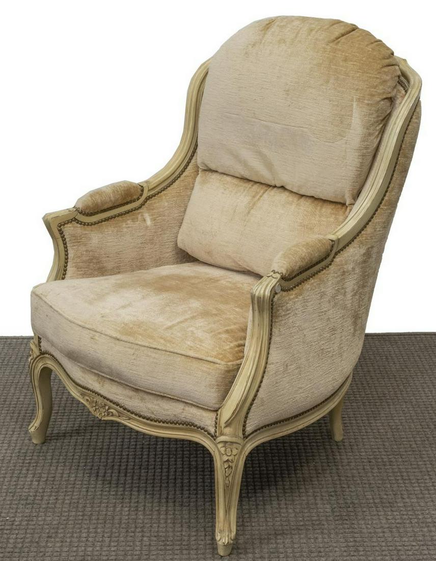 FRENCH LOUIS XV STYLE PAINTED BERGERE ARMCHAIR: French Louis XV style painted bergere armchair, 20th c., having floral carved frame, well padded upholstered back and loose cushion seat, all on cabriole legs, approx 39.25"h, 29.25"w, 26"d Start Pric