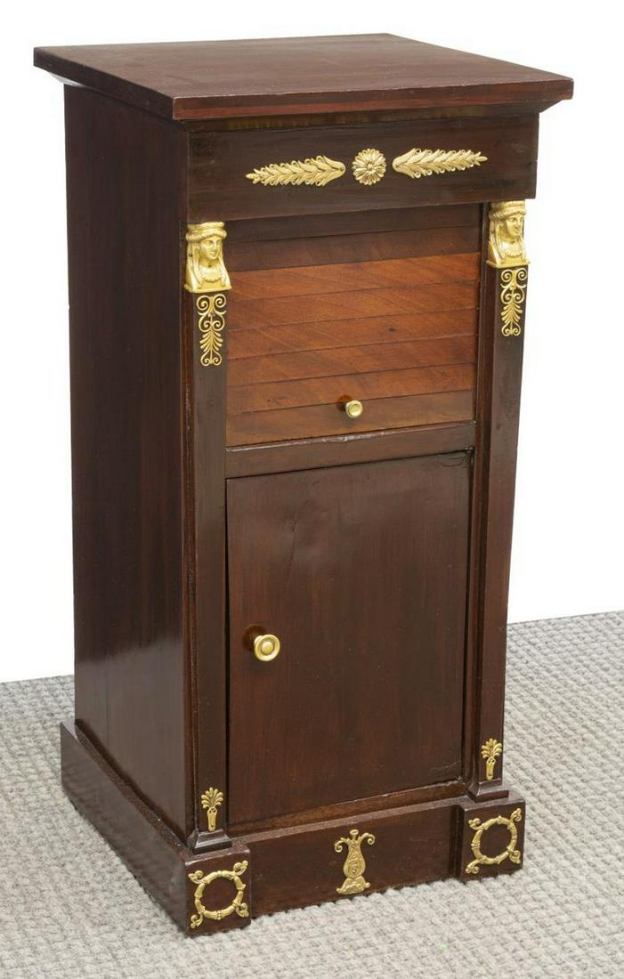 EMPIRE STYLE ORMOLU-MOUNTED MAHOGANY NIGHTSTAND: French Empire style mahogany nightstand, late 19th c., ormolu-mounted frieze and corner post terminals, case fitted with tambour center compartment, over cabinet door opening to interior shelves, risi