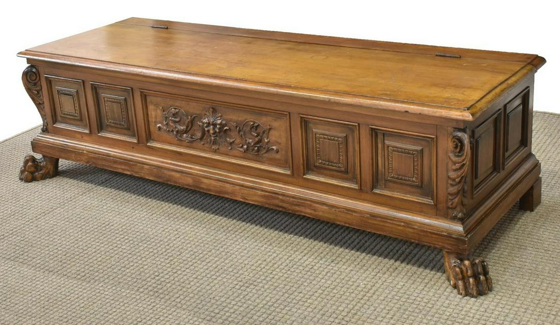 ITALIAN RENAISSANCE REVIVAL CARVED TRUNK/ COFFER: Italian Renaissance Revival walnut storage trunk/ coffer, 20th c., rectangular top opening to open interior storage, having registers with scrollwork, scalloped carving, and dragon motifs, rising on s