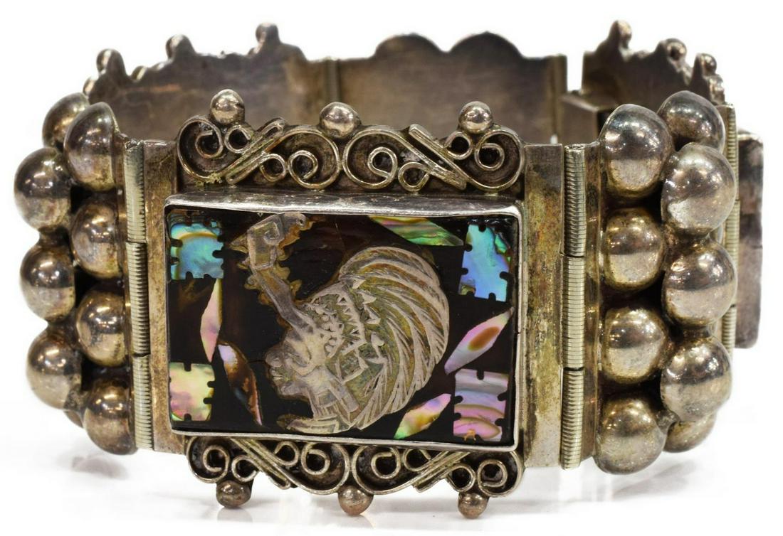 FARFAN MEXICO STERLING & ABALONE MASK BRACELET: Sterling silver link bracelet, Farfan, Mexico, mid 20th c., with abalone shell inlay, Pre-Columbian inspired mask motif, approx 7 1/8"l, 1 3/8"w, 57 grams (inclusive of all materials) Start Price: $60