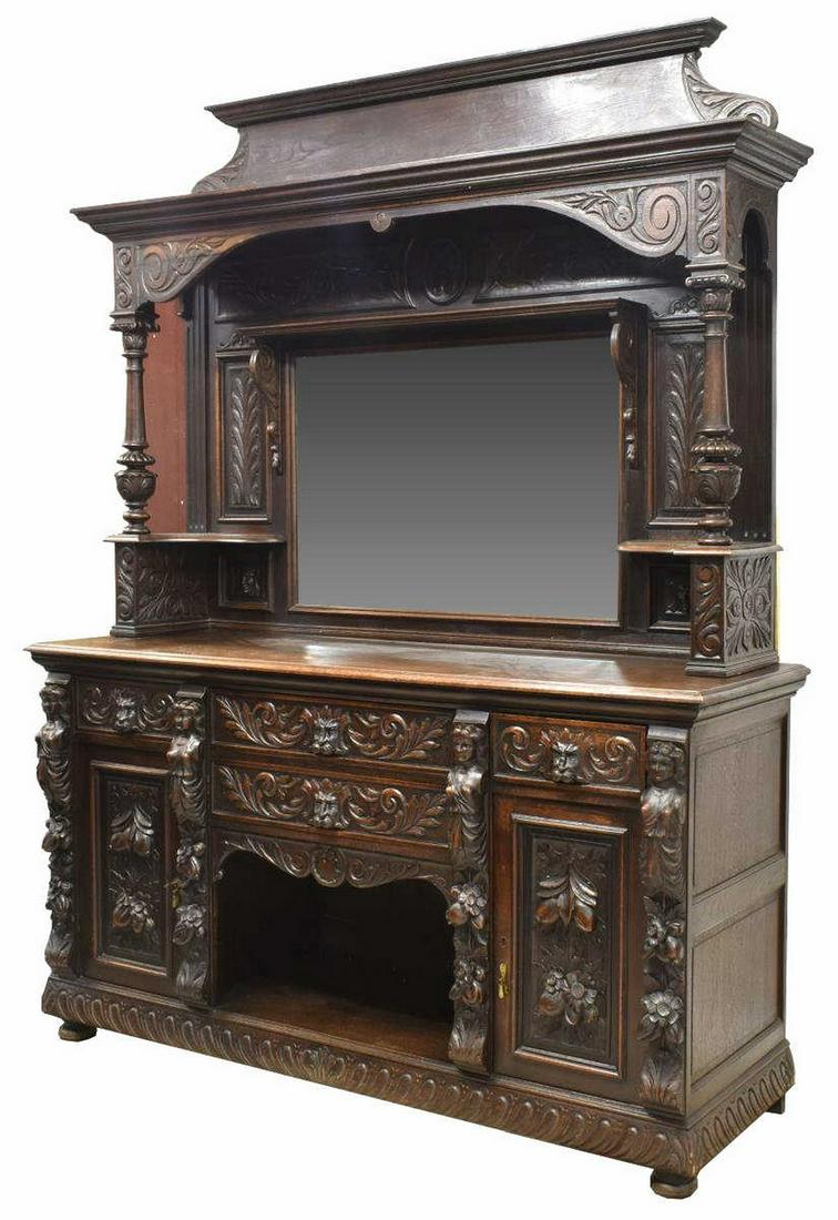FRENCH HENRI II STYLE CARVED OAK BUFFET DEUX CORPS: French Henri II style carved oak buffet deux corps, 19thc., having crown molding, flanked by scrolling supports, over molded cornice, with heavily carved scrolling foliates, figural forms, and grotesq
