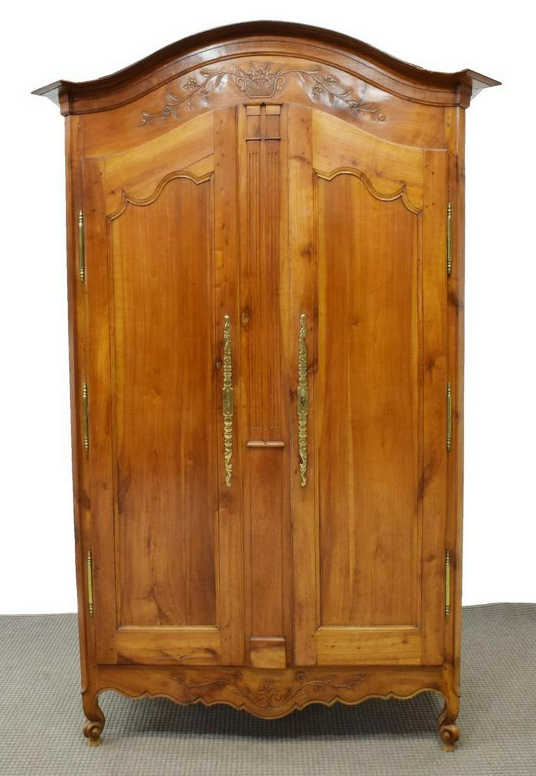 FRENCH PROVINCIAL LOUIS XV STYLE WALNUT ARMOIRE: French Provincial Louis XV style walnut armoire, 19th c., having carved foliates, arched cornice, over double doors, opening to one adjustable interior shelf, with scrolling gilt escutcheon, flanking 