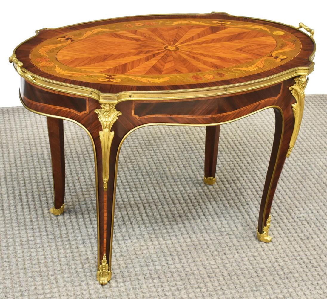 PETITE LOUIS XV STYLE METAL-MOUNTED COFFEE TABLE: Louis XV style gilt metal mounted coffee table, 20th c., shaped tabletop with radiating parquetry, contrasting floral and scrolling foliate marquetry border, rising on cabriole legs with figural mount