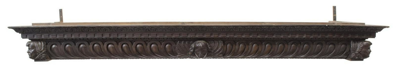 ITALIAN ARCHITECTURAL CARVED MASK PELMET VALANCE: Italian architectural pelmet/ valance, early 20th c., cornice with foliate, egg and dart, and dentil molding, central carved winged angel mask, with additional masks at the corners, approx 8.25"h, 76"
