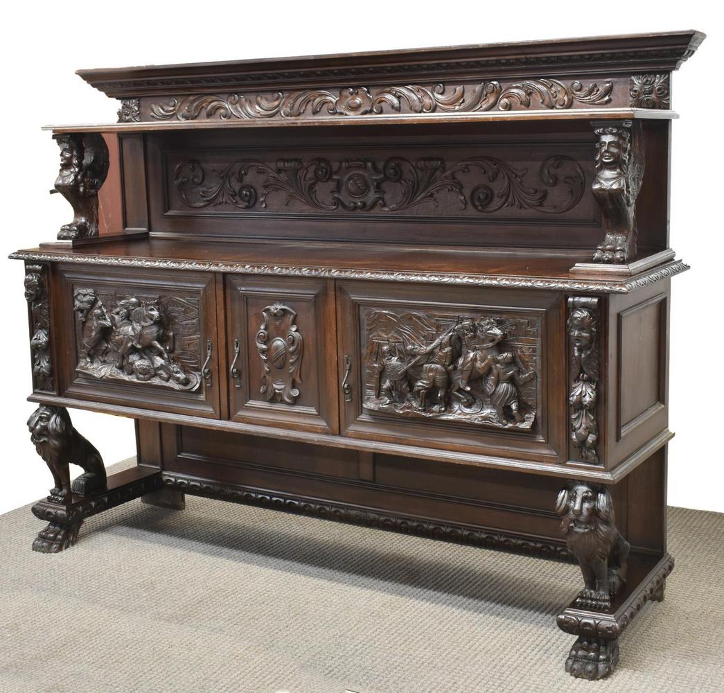 RENAISSANCE REVIVAL FIGURAL CARVED LION SIDEBOARD: Italian Renaissance Revival carved walnut sideboard, early 20th c., scrolling acanthus on the splash back, featuring a shelf supported by winged figures, lower case having a rectangular top with carve