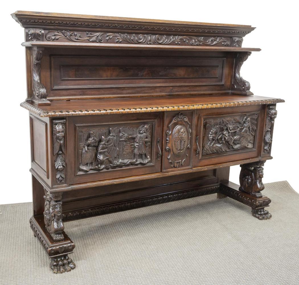 RENAISSANCE REVIVAL FIGURAL CARVED SIDEBOARD: Italian Renaissance Revival walnut sideboard, early 20th c., heavily carved throughout with egg-and-dart borders, scrolling foliates, figural motifs, birds, female heads, and winged putti, having crow