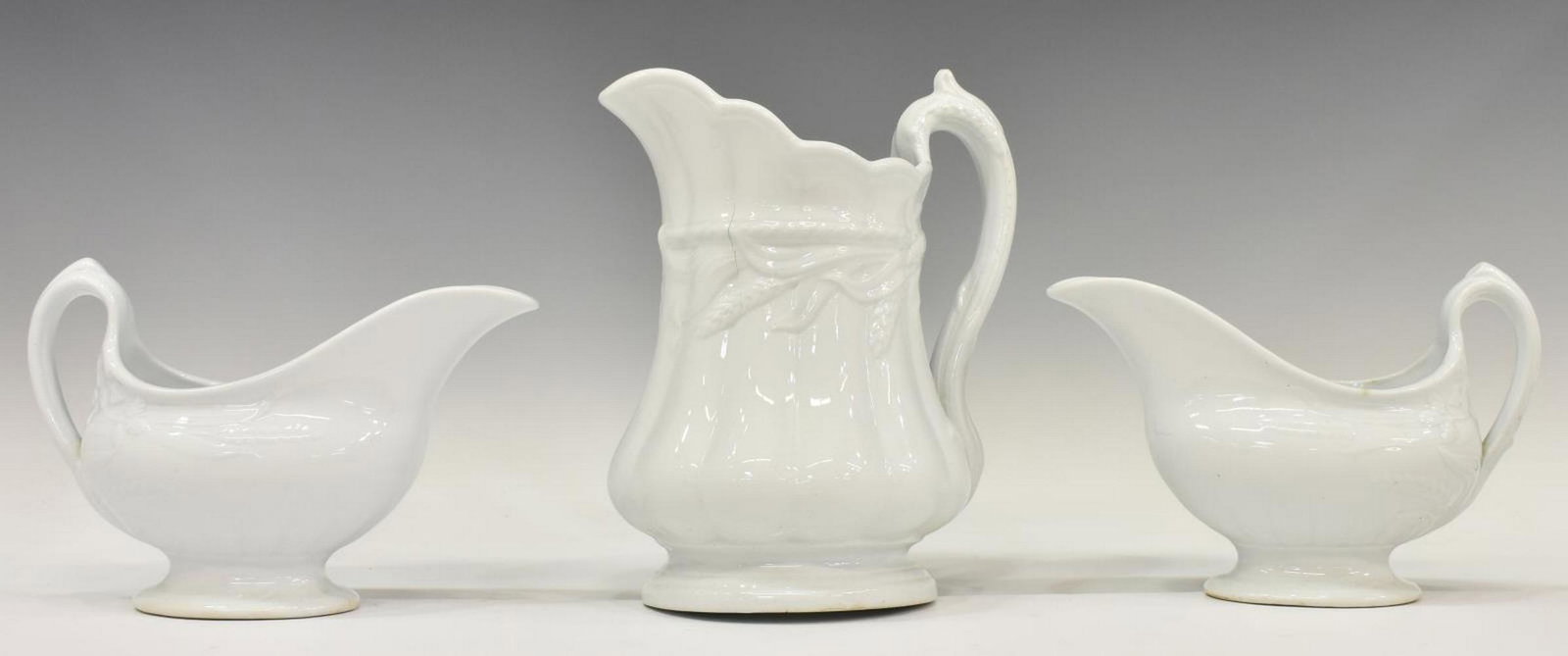 (3) ENGLISH WHITE IRONSTONE GRAVY BOATS & PITCHER: (lot of 3) English white ironstone tableware, mid to late 19th c., including: (2) gravy boats, in the wheat and hops pattern (also known as wheat and blackberry), approx 5.5"h, 8.25"w, 3.5"d, (1) pitc