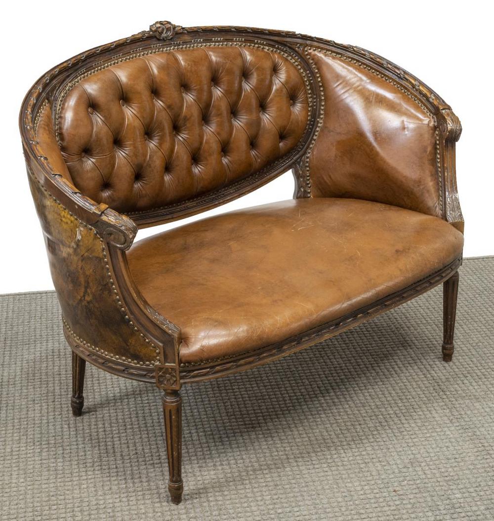 LOUIS XVI STYLE BUTTON-TUFTED CANAPE SOFA: Louis XVI style canape sofa, 20th c., carved frame with ribbon crest, button-tufted back, closed arms, acanthus scroll handholds, rising on tapered fluted legs, approx 36.5"h, 47.25"w, 24"d Start Pric