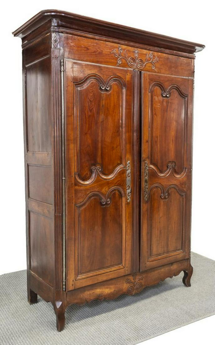 FRENCH PROVINCIAL FRUITWOOD DOUBLE-DOOR ARMOIRE: French Provincial fruitwood armoire, 19th c., having crown molding, scrolled paneled double doors, opening to interior drawers and open storage, long visible hinges, elaborate scrolling escutcheon, fl