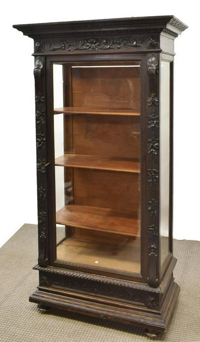 FRENCH HENRI II STYLE WALNUT VITRINE CABINET: French Henri II style walnut vitrine, 19th c., having cornice top, frieze with carved mask and foliate accents, glazed door and side panels, opening to shelved interior, rising on bun feet, approx 72"