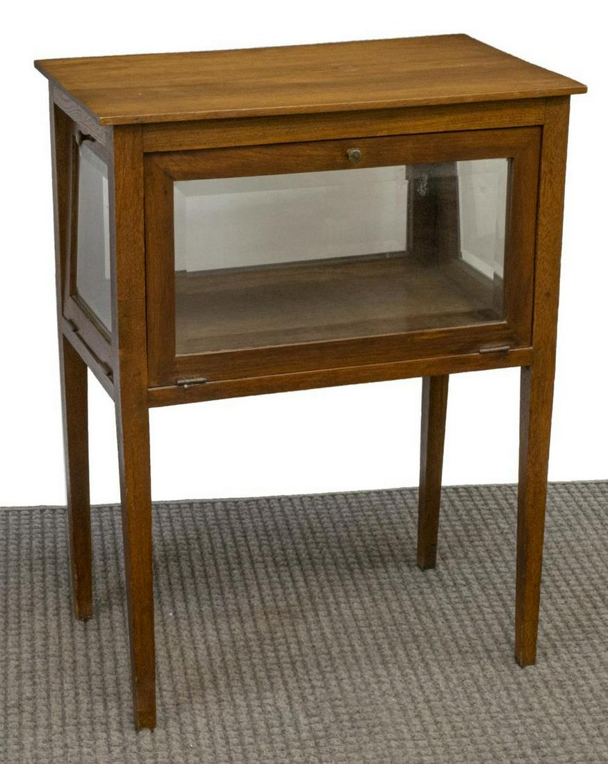 FRENCH OAK GLAZED DROP PANEL TEA TABLE, 19TH C: French oak tea table, 19th c., rectangular top, having glass paneling inset into hinged drop-down doors, rising on tapered legs, approx 29.5"h, 22.5"w, 13.75"d Start Price: $200.00