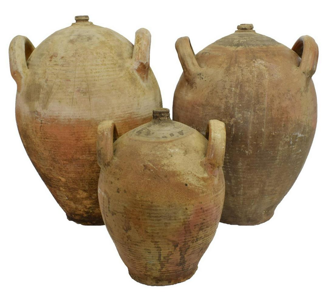 (3) ANTIQUE FRENCH EARTHENWARE HANDLED JUGS: (lot of 3) French earthenware jugs, 19thc., each handled vessel of varied size, one with a top spout, largest: approx 20"h, 13.5"w; 20lbs total Start Price: $100.00