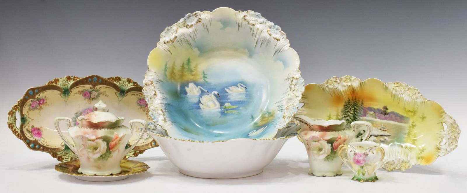 (8) R.S. PRUSSIA PARCEL GILT PORCELAIN TABLEWARE: (lot of 8) R.S. Prussia porcelain tableware, with various hand painted and transfer floral designs and gilt detail, all marked underfoot, including: (1) cream pitcher, approx 3.75"h, 3.5"w, 5"d; (1) m
