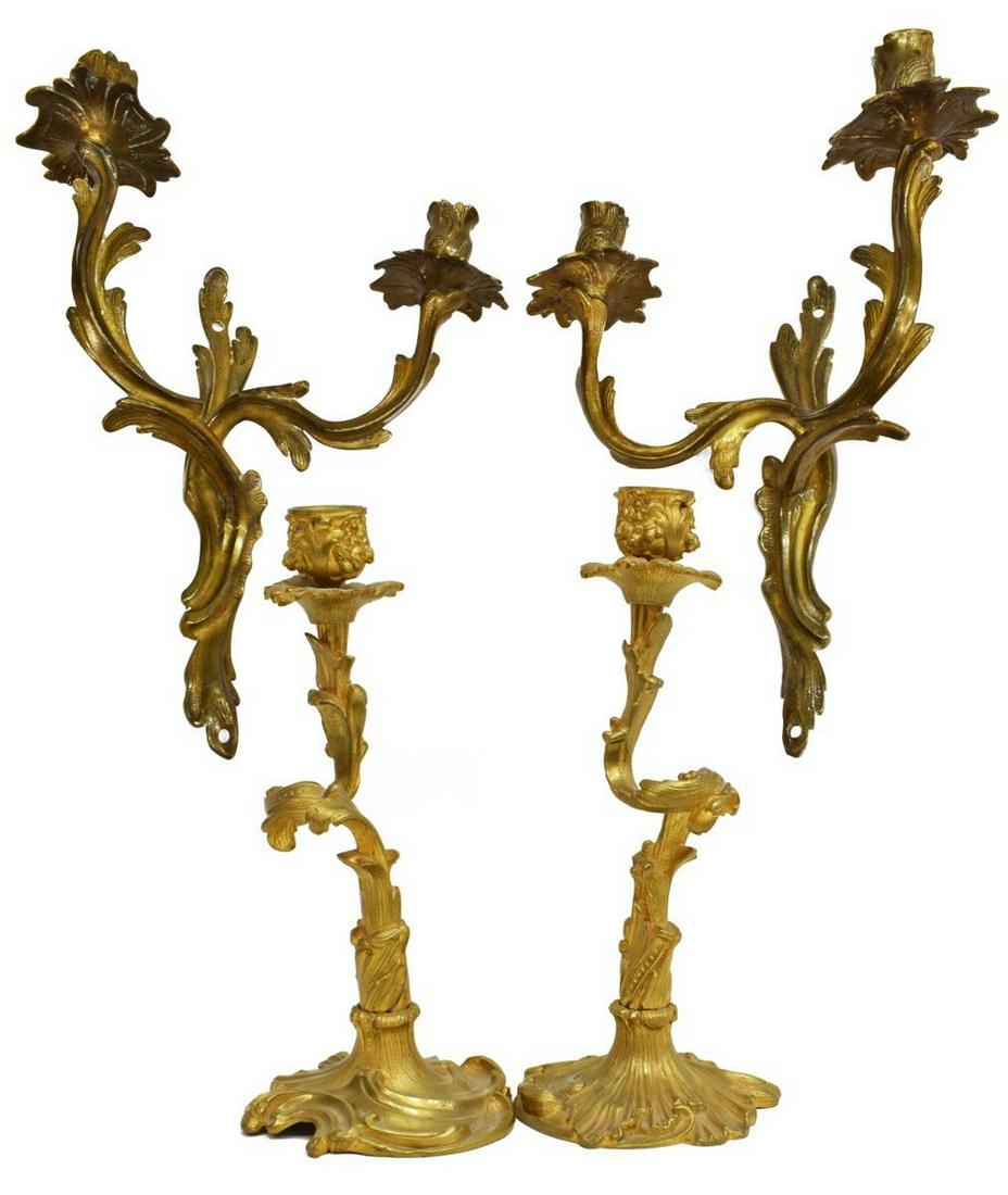 (4) LOUIS XV STYLE BRONZE SCONCES & CANDLESTICKS: (lot of 4) Louis XV style gilt bronze wall sconces and candlesticks, comprising: (2) sconces, with two scrolling arms, terminating in candle holders, approx 14"h, 11"w, 5.75"d; (2) candlesticks, with 