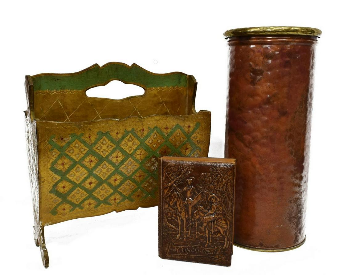 (3) FLORENTINE MAGAZINE STAND, BOOK-FORM CIGAR BOX: (lot of 3) Decorative items, including: (1) Florentine gilt magazine stand, approx 17"h, 14.75"w, 8"d, (1) mixed metal umbrella stand, approx 19.25"h, 8.75"diam, (1) Don Quixote book-from cigar/ cigar