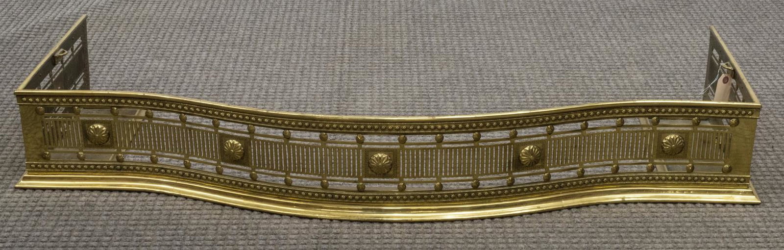 HEAVY PIERCED GILT BRASS FIRE FENDER: Heavy gilt brass fire fender, having a curved form rail with pierced sides, with floral accents and trim, approx 7.5"h, 50.25"w, 15.75"d Start Price: $50.00