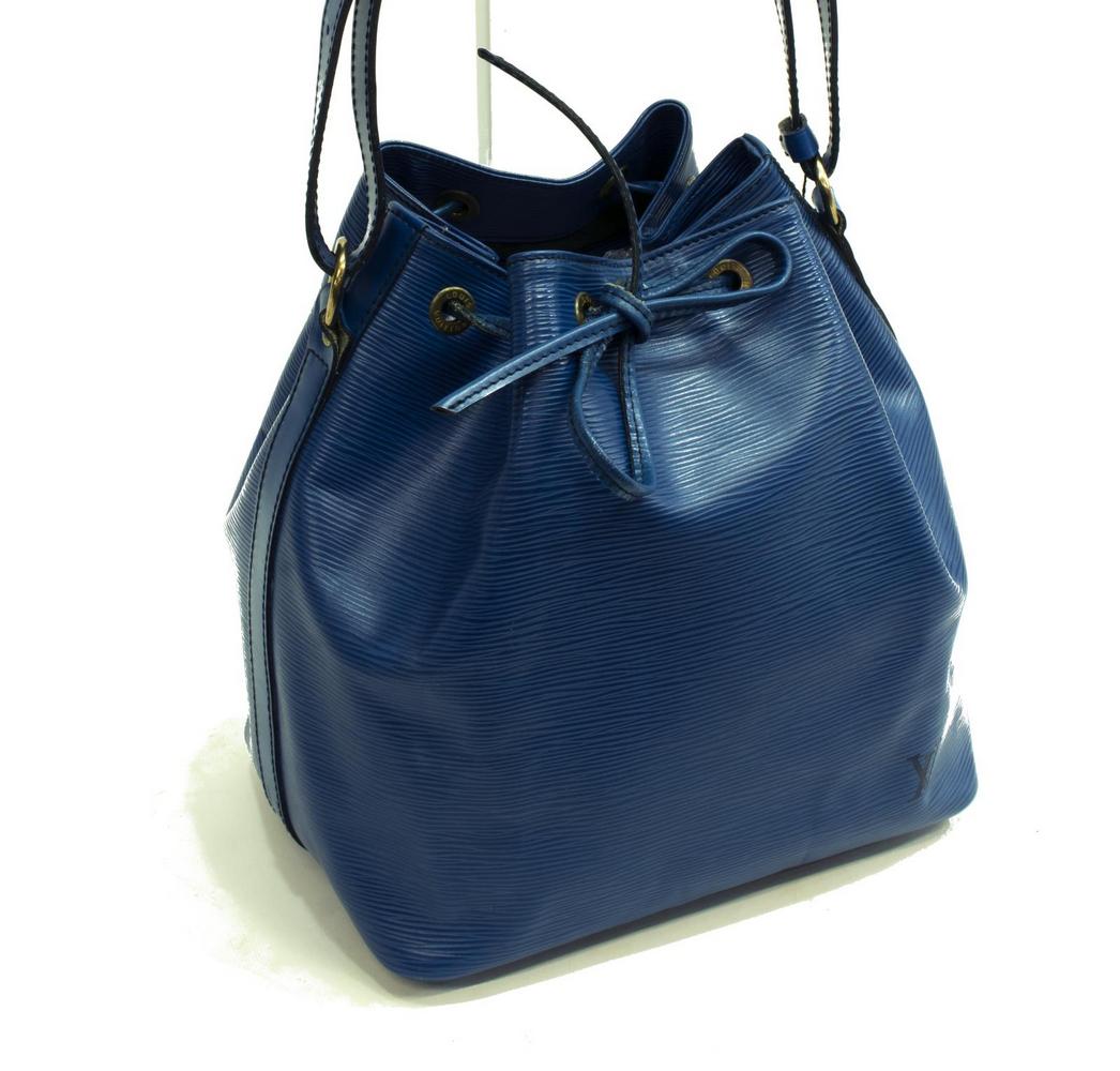 LOUIS VUITTON 'NOE PM' BLUE EPI LEATHER BUCKET BAG: Louis Vuitton "Noe PM" bucket bag, in blue Epi leather, with brass hardware, adjustable flat shoulder strap, drawstring closure at front face, creasing and scratches with loss to the coloring along lo