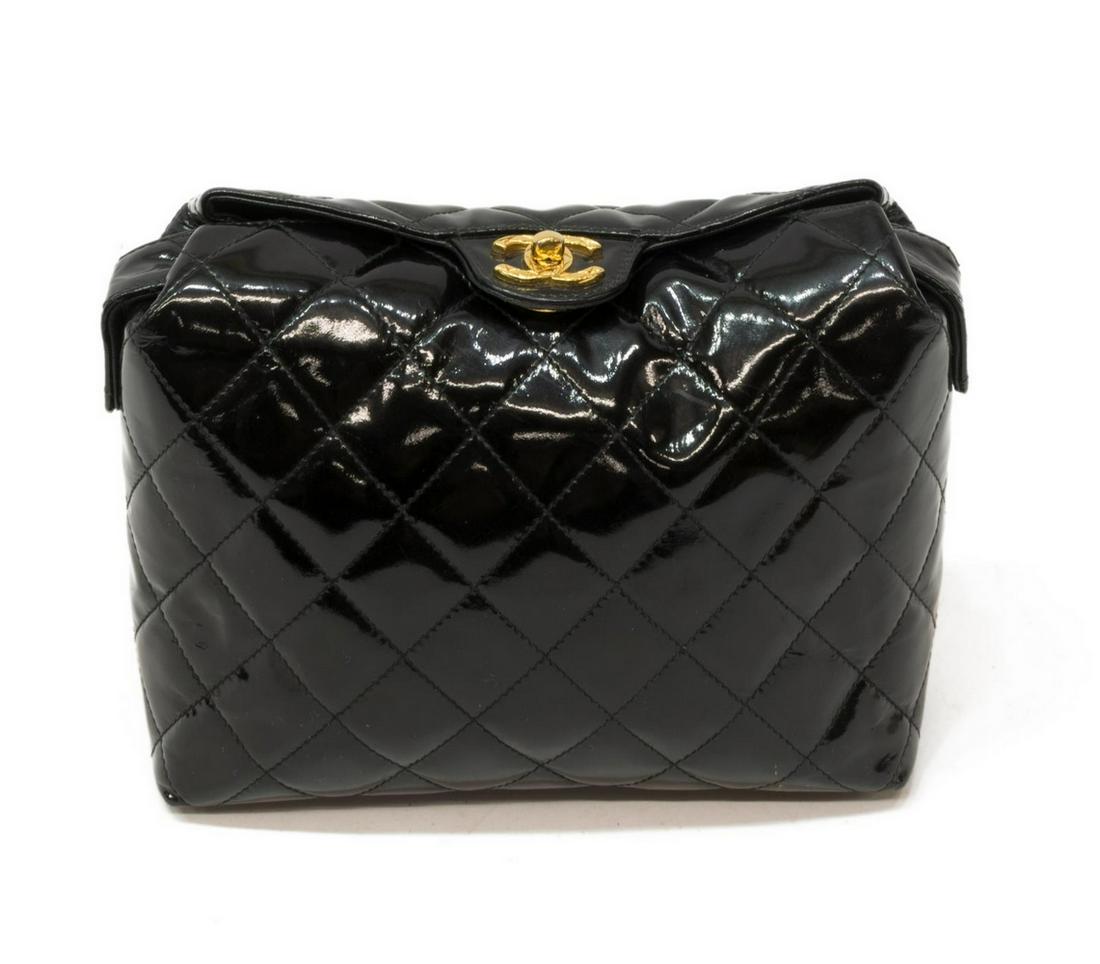 CHANEL QUILTED BLACK PATENT LEATHER SHOULDER BAG: Chanel shoulder bag, in quilted black patent leather, with gold-tone hardware, single flat shoulder strap, exterior slot pocket, turn-lock closure at top, opening to leather-lined interior with single