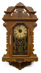 AMERICAN INGRAHAM CONNECTICUT OAK CASED WALL CLOCK: American Victorian oak cased wall clock, E. Ingraham Company, Bristol, Connecticut, paper dial with roman numerals, time and strike movement, glazed door with stenciled design, case with thermometer a